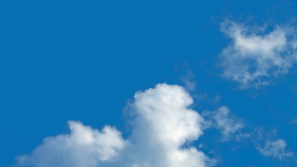 Photo of clouds passing shows how pain journaling help dissipate chronic pain for a higher quality of life.