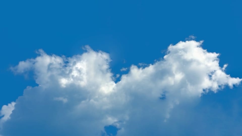 Photo of clouds shows the positive health benefits of using journaling to release chronic pain.